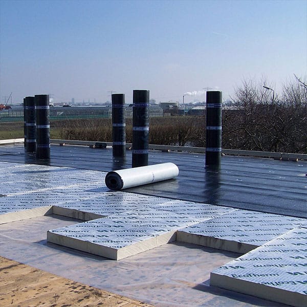 Professionele aanleg plat dak met isolatieplaten en bitumen rolbedekking tijdens renovatie